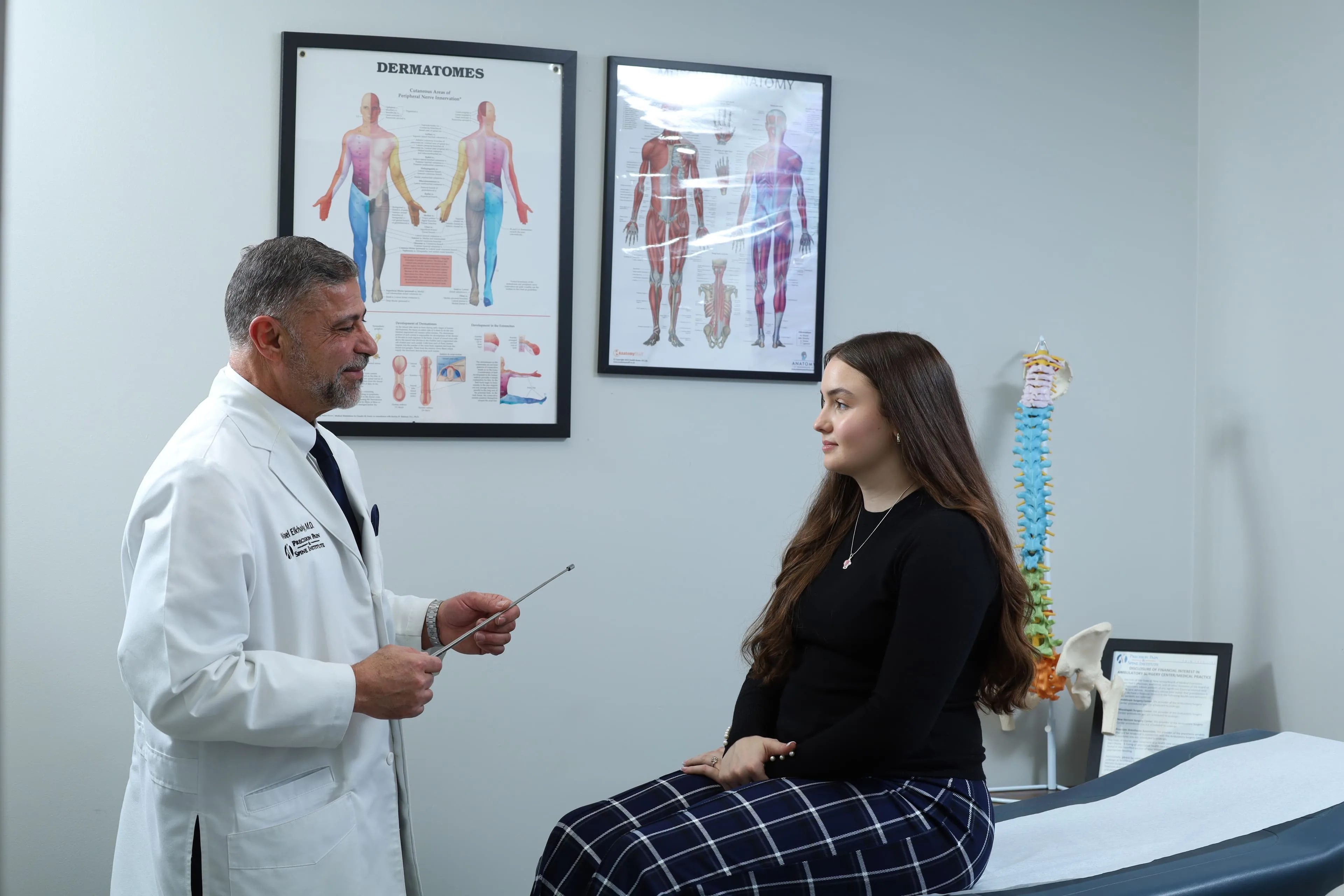 Doctor and patient discussing care at Precision Pain & Spine Institute